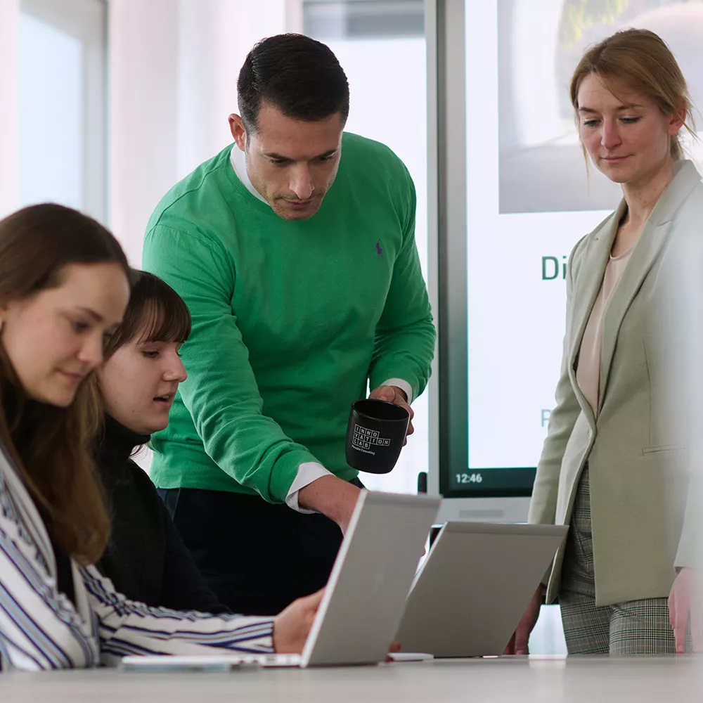 Colleagues with a laptop have a meeting in the office
