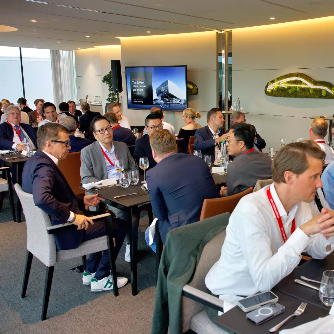 Guests sitting at the battery show europe pre-event hosted by porsche consulting