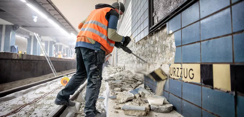 Construction worker demolishing a wall