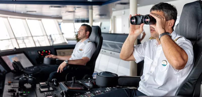 Captain looking through binoculars