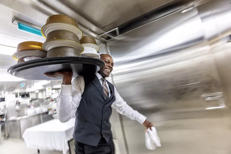 Waiter on his way to serve food