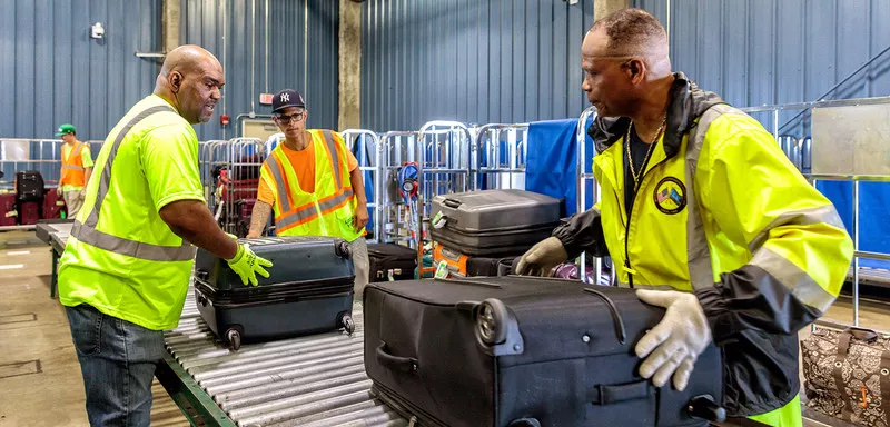 Workers handling luggage