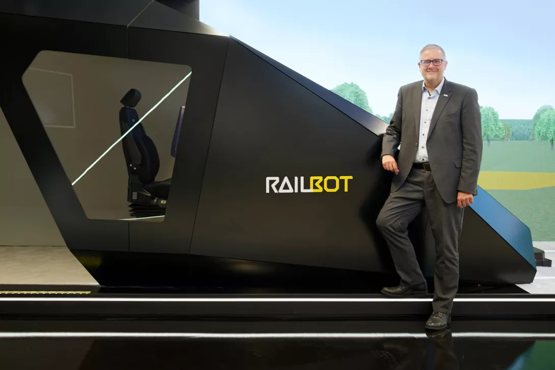 In front of the “Railbot” in the Hitachi Rail showroom in Ditzingen, near Stuttgart: In his role as Vice President Markets Germany & Global Account Manager Deutsche Bahn, Markus Fritz is driving forward the modernization of rail transport in Germany.