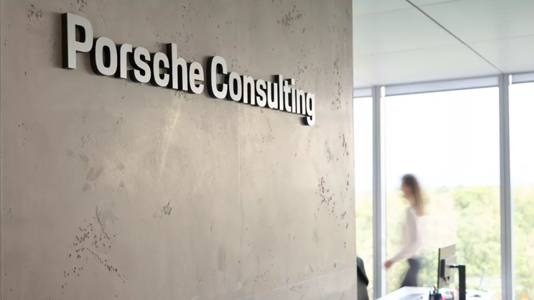 Wall in an office with the lettering Porsche Consulting