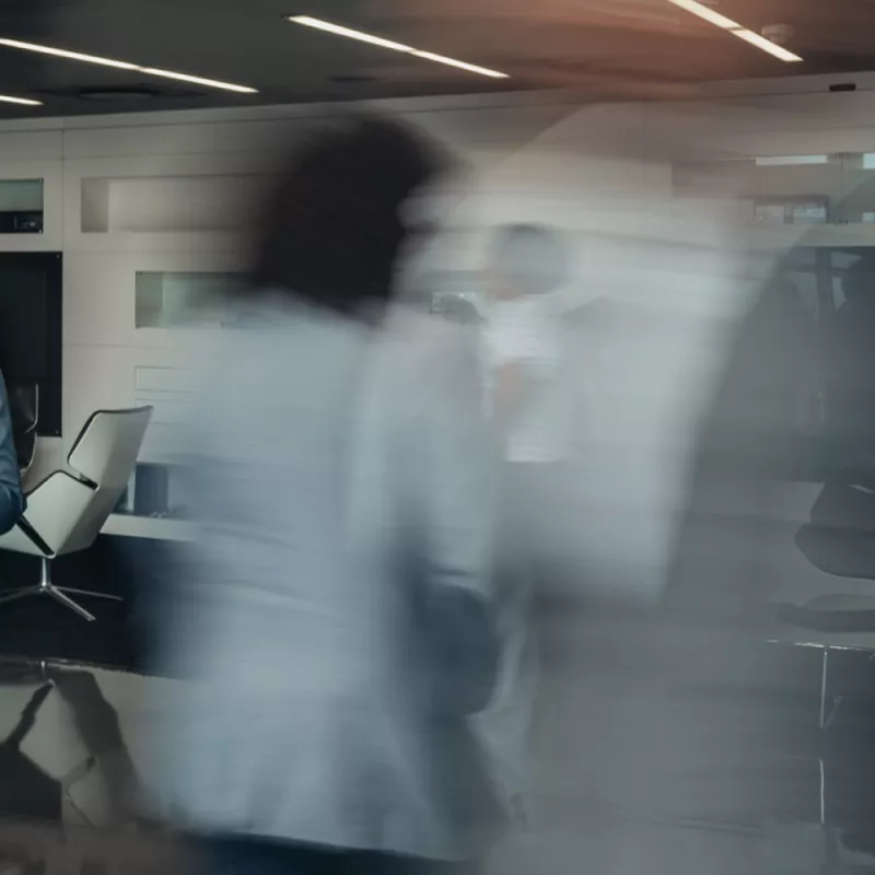 Blurred shot of a man from behind in an office